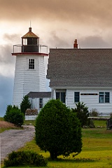 Sun Breakes Through Clouds at Wings Neck Light